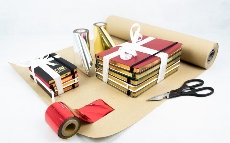 Notebooks being wrapped in paper and ribbon
