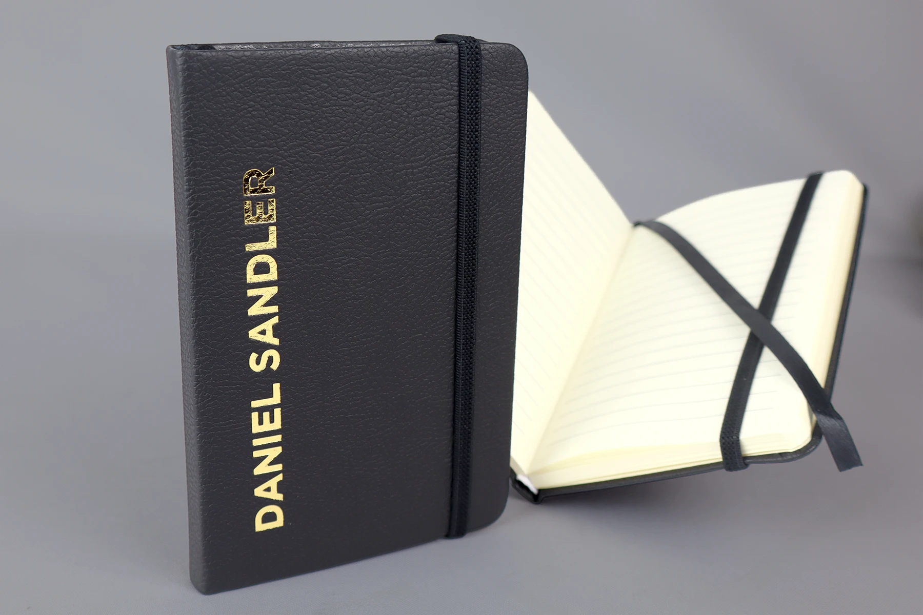 Daniel sandler custom branded pocket notebook in black, with gold foil printed logo