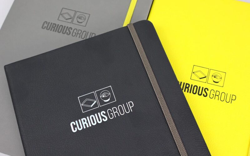 Curious notebooks in black, yellow and grey.