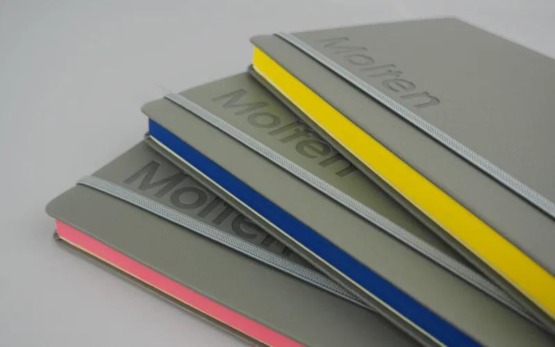 Bespoke notebooks for Molten. They are grey with debossed logos, and colourful page edges.